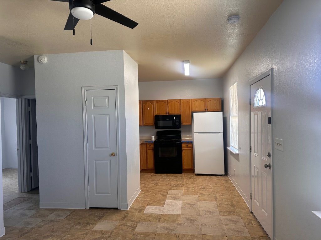 251 Zimmerman Avenue, Unit A Bastrop, TX 78602 - Photo 3 of 8 a view of a hallway with a refrigerator