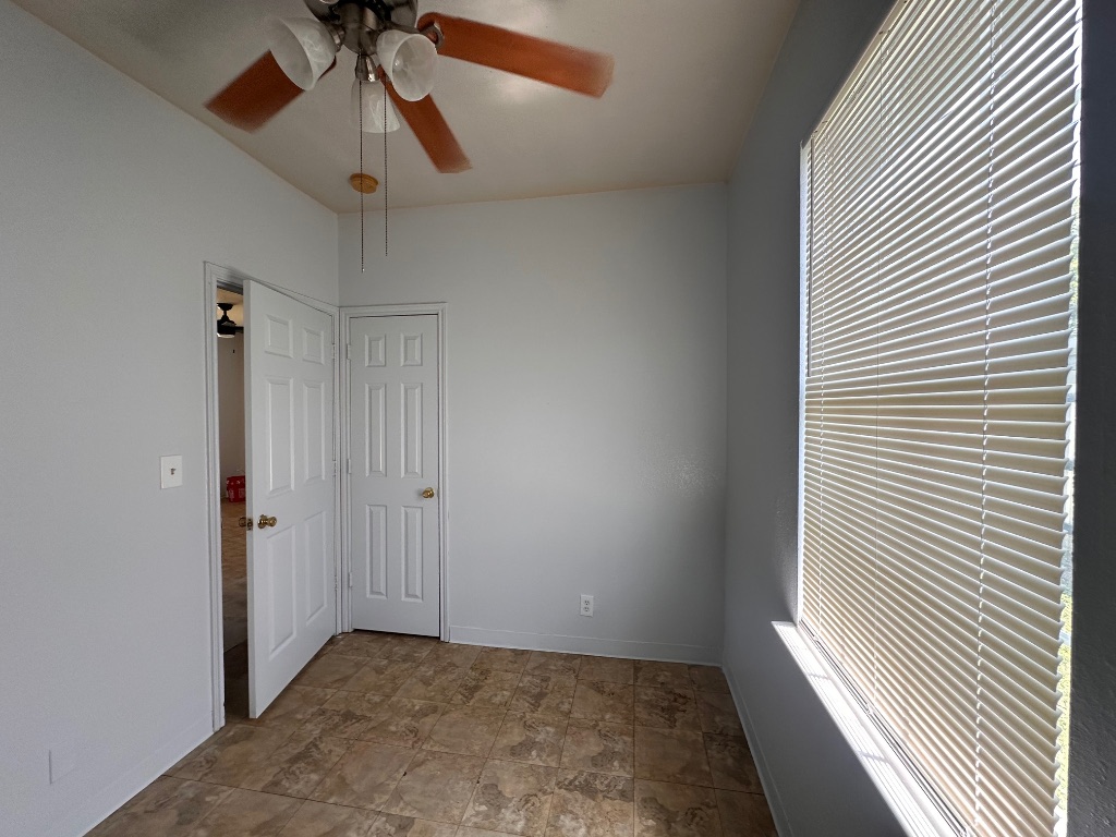 251 Zimmerman Avenue, Unit A Bastrop, TX 78602 - Photo 7 of 8 a view of a hallway with a chandelier fan