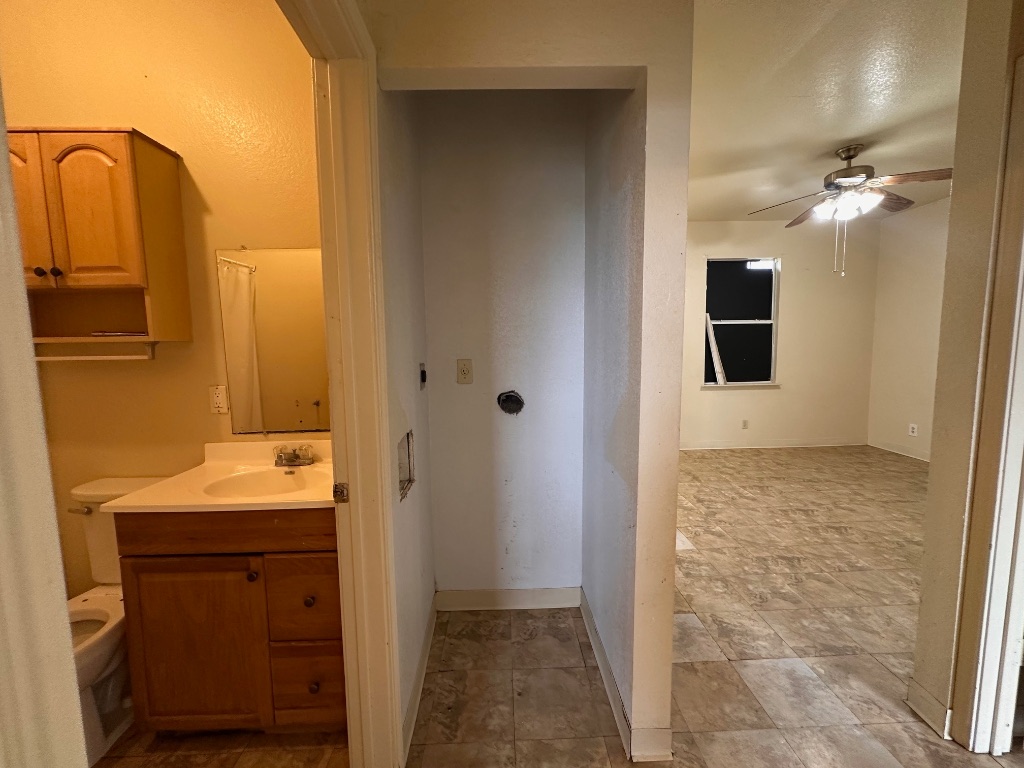 251 Zimmerman Avenue, Unit A Bastrop, TX 78602 - Photo 8 of 8 a bathroom with a sink and a mirror