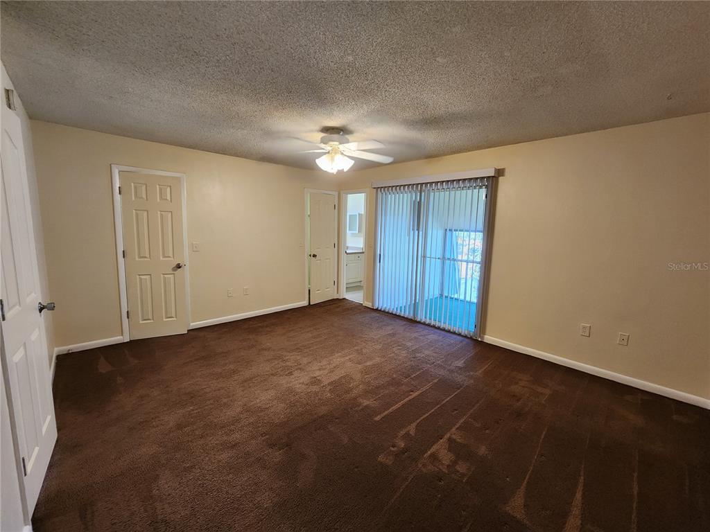 501 Southwest 75th Street, Unit A14 Gainesville, FL 32607 - Photo 45 of 56 a view of an empty room and chandelier fan