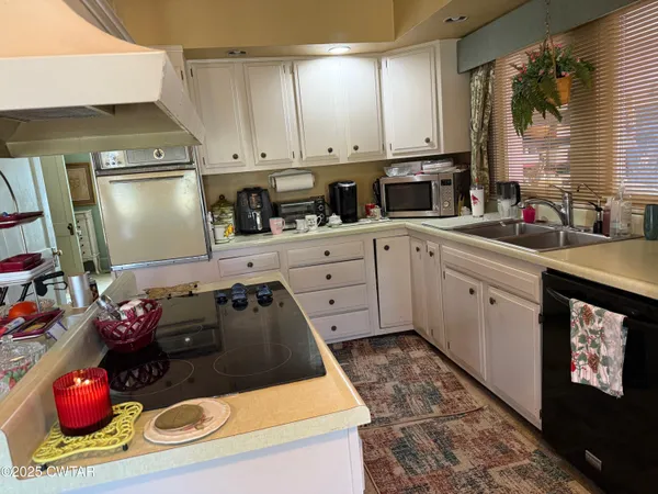 a kitchen with a sink stove and refrigerator