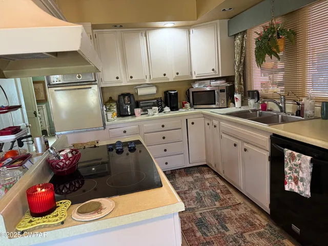 a kitchen with a sink stove and refrigerator