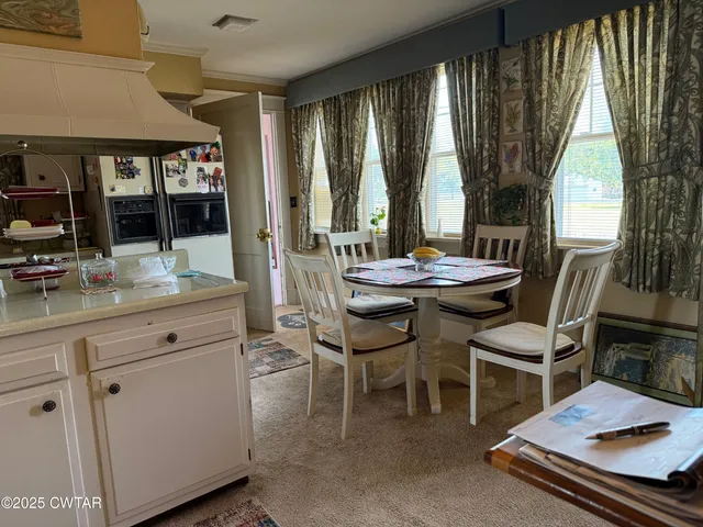 a view of a kitchen with appliances and a workspace