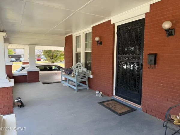 a living room with furniture gym equipment and large windows