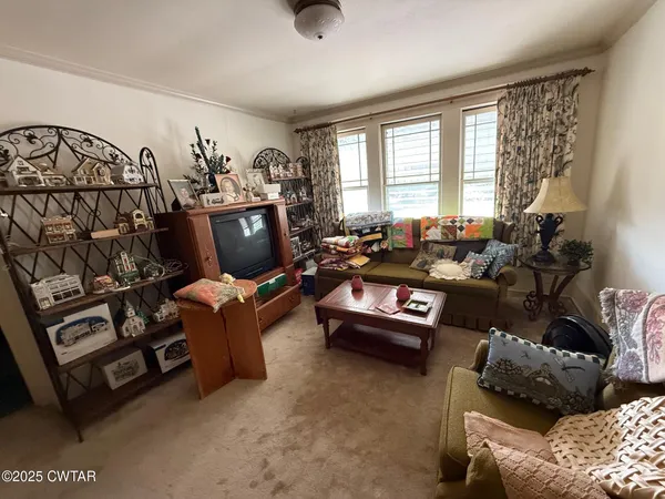 a bedroom with a bed a large window and flat screen tv
