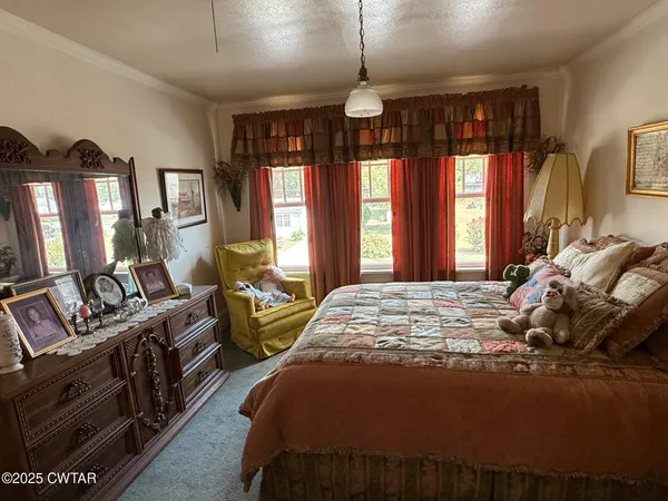 a living room with furniture a rug and a large window