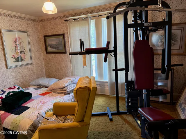a view of a patio with chairs and potted plants