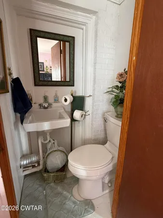 a view of a dining room with furniture water view and a floor to ceiling window