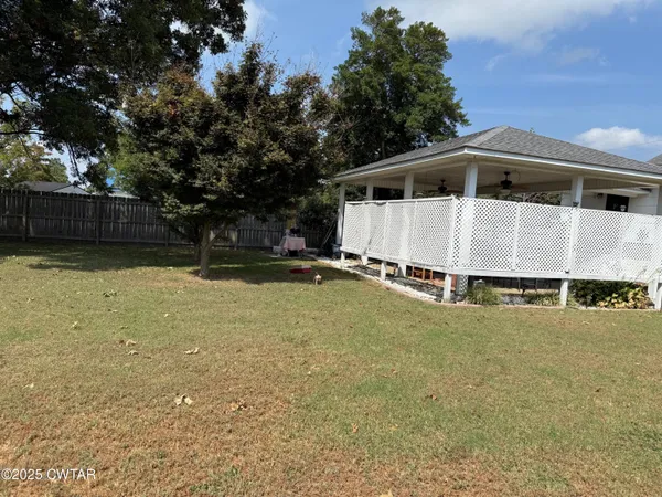 a living room with lots of furniture and a view of kitchen