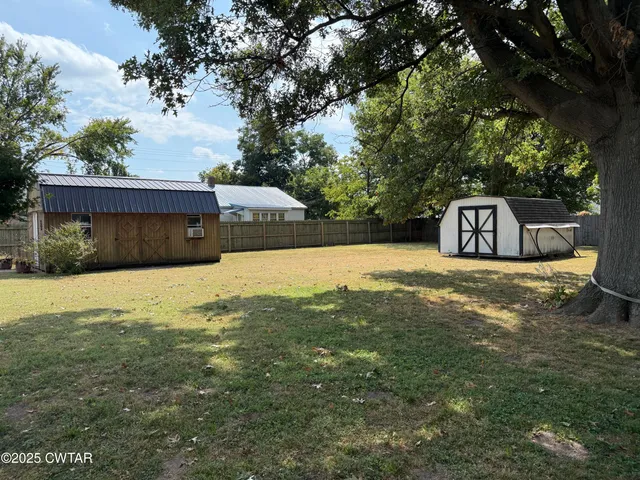 a front view of house with yard outdoor seating and barbeque oven