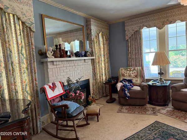 a living room with furniture and a fireplace
