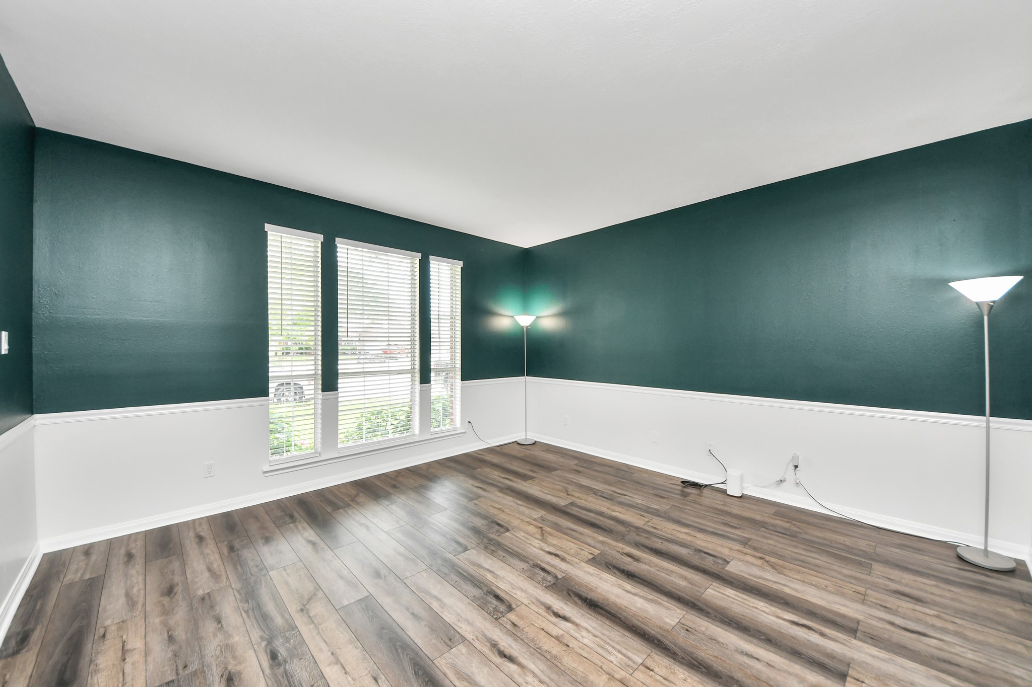 7622 McCormick Mill Court Houston, TX 77095 - Photo 10 of 37 a view of an empty room with wooden floor and a window