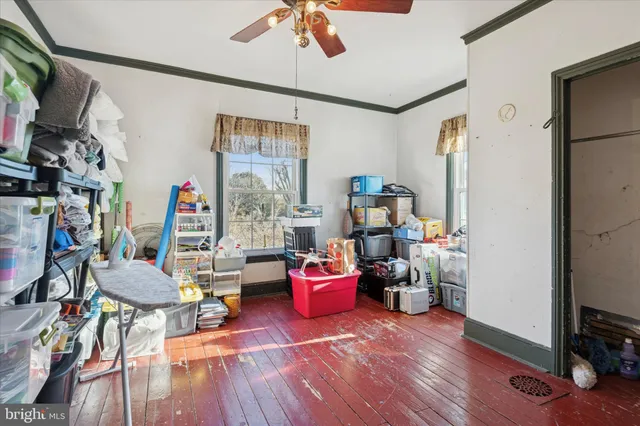 a living room with furniture or wooden floor and a flat screen tv