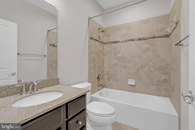 an empty room with wooden floor and mirror