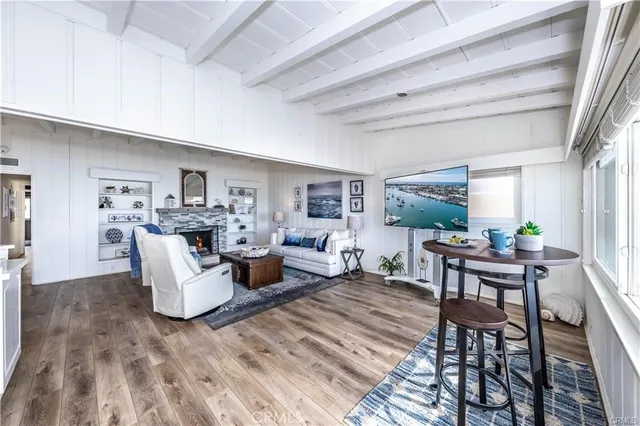 a living room with fireplace furniture and a rug