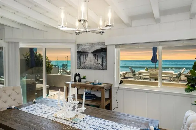 a dining room with wooden floor and a floor to ceiling window