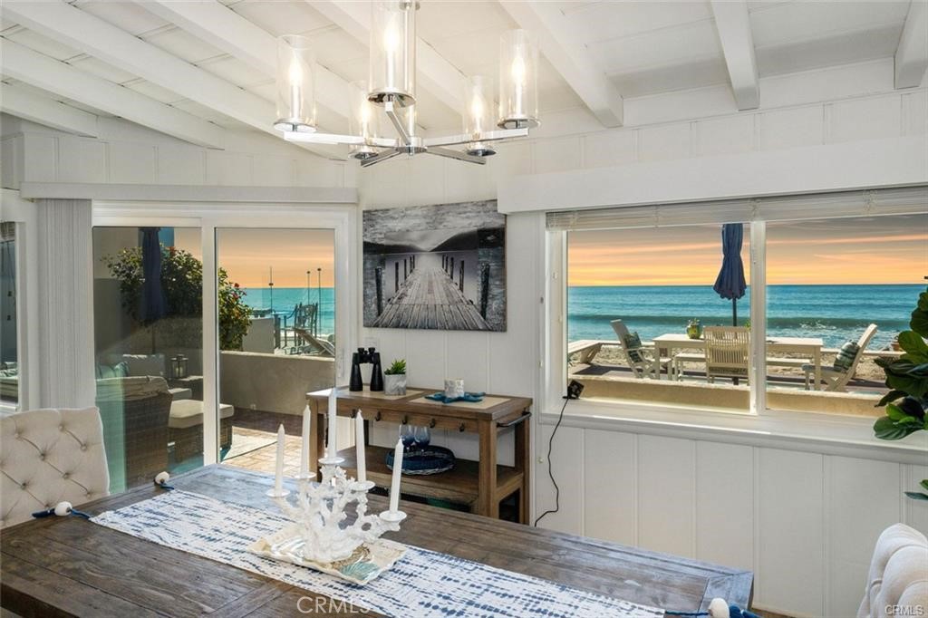 35325 Beach Road Dana Point, CA 92624 - Photo 2 of 44 a dining room with wooden floor and a floor to ceiling window