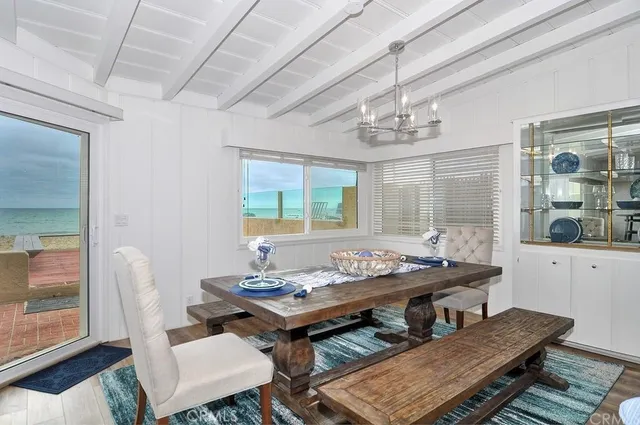 a dining room with furniture a rug and a chandelier