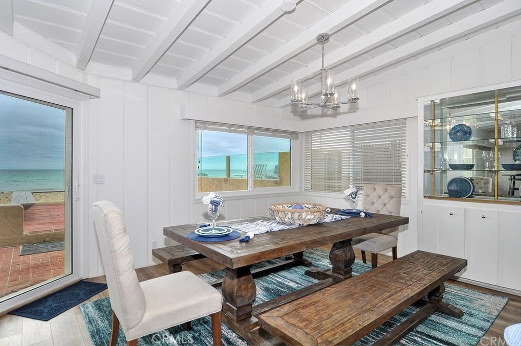 35325 Beach Road Dana Point, CA 92624 - Photo 21 of 44 a dining room with furniture a rug and a chandelier