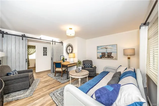 a living room with furniture and wooden floor