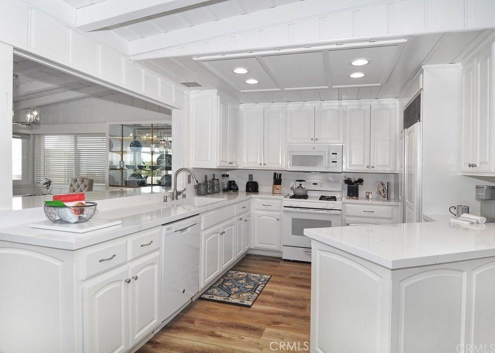 35325 Beach Road Dana Point, CA 92624 - Photo 26 of 44 a kitchen that has a lot of white cabinets and stainless steel appliances