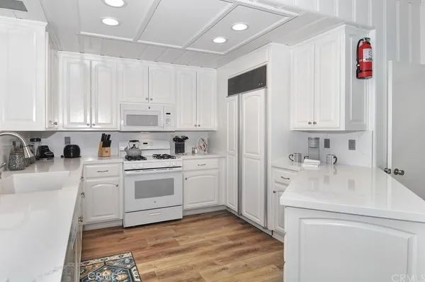 a kitchen with stainless steel appliances granite countertop a sink and cabinets