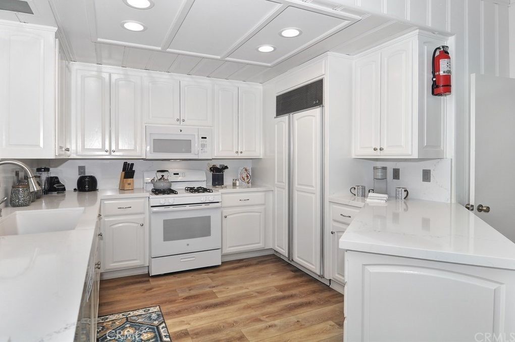 35325 Beach Road Dana Point, CA 92624 - Photo 27 of 44 a kitchen with stainless steel appliances granite countertop a sink and cabinets
