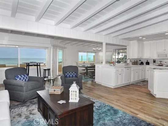 a living room with furniture and kitchen view