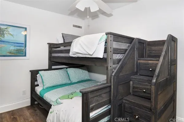 a bedroom with furniture and a ceiling fan