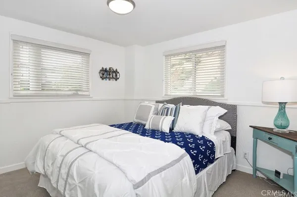 a bedroom with a bed and a lamp