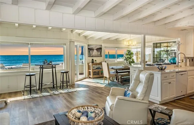 a living room with fireplace furniture and a large window