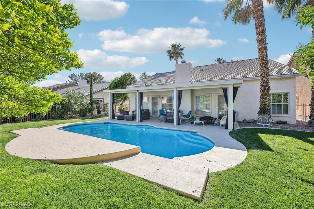 5236 Saranac Road Las Vegas, NV 89130 - Photo 44 of 52 This private backyard oasis features a sparkling in-ground pool and lush green lawn.