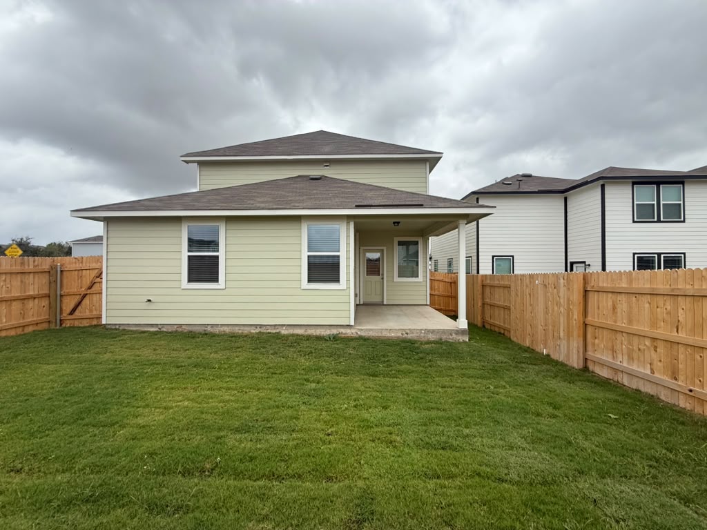 2601 Foss Road Manor, TX 78653 - Photo 25 of 40 A spacious grassy lawn is enclosed by a tall wooden privacy fence.