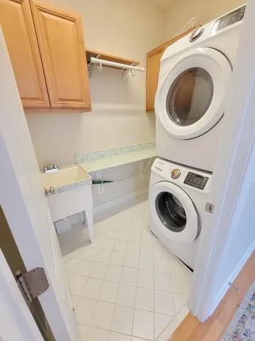 a view of an empty room with window and hardwood floor