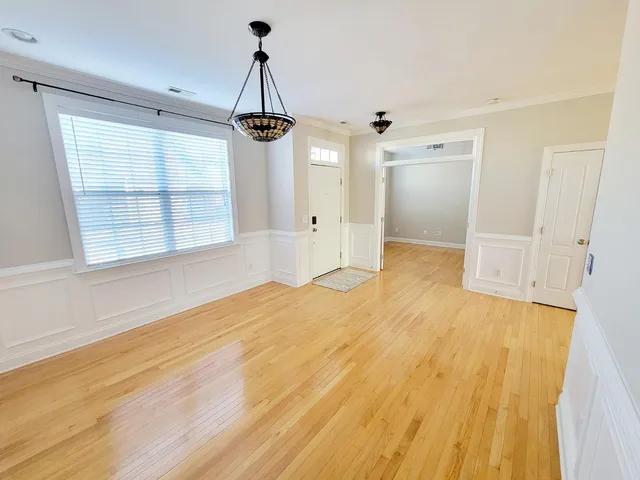 a view of an empty room with a fireplace and a window