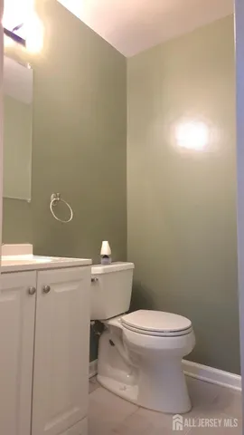 a white toilet sitting next to a shower