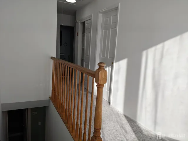 a view of a hallway with stairs