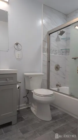 a bathroom with a toilet a sink and shower