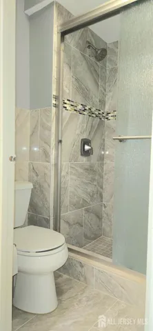 a white toilet sitting next to a bathroom sink