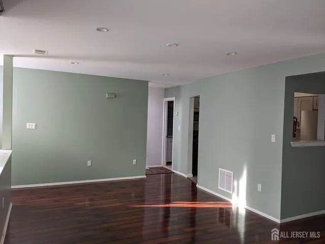 a view of room with wooden floor