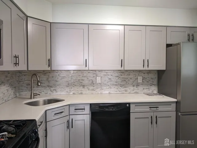 a kitchen with a sink and cabinets