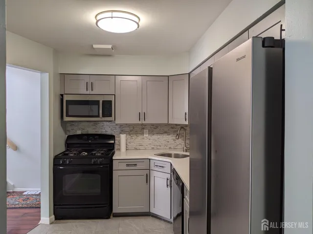 a kitchen with a refrigerator stove and microwave