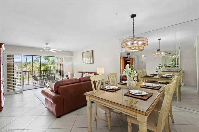 a view of a dining room and livingroom furniture wooden floor a chandelier and a rug