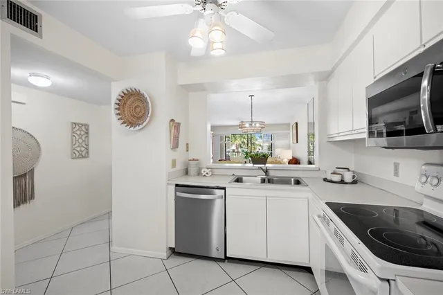 a kitchen with a sink cabinets and window