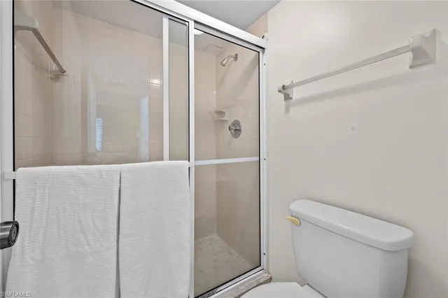 a bathroom with a shower and toilet