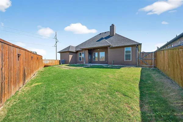 a view of a house with a yard and porch