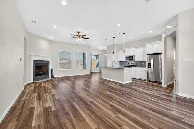a view of kitchen with cabinets appliances and wooden floor