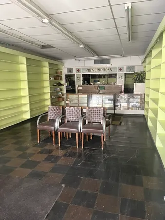 a outdoor space with lots of tables a chairs and a rug