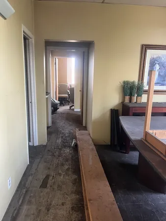 a view of a hallway with furniture and a window