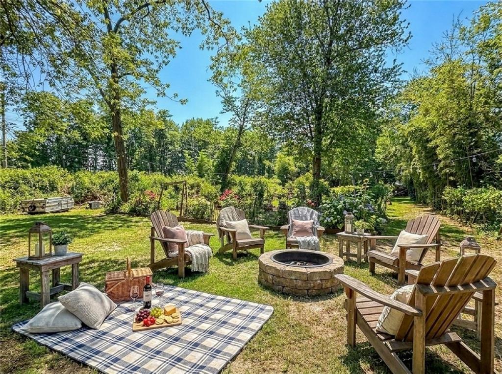 636 Holmdel Road Hazlet, NJ 07730 - Photo 41 of 47 a view of a patio with table and chairs potted plants and a lake view